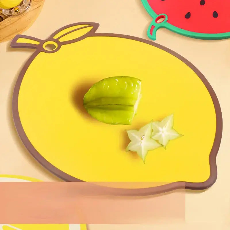 Bright yellow fruit shape silicone chopping board with brown border and leaf handle featuring sliced starfruit decorbites fruit shape