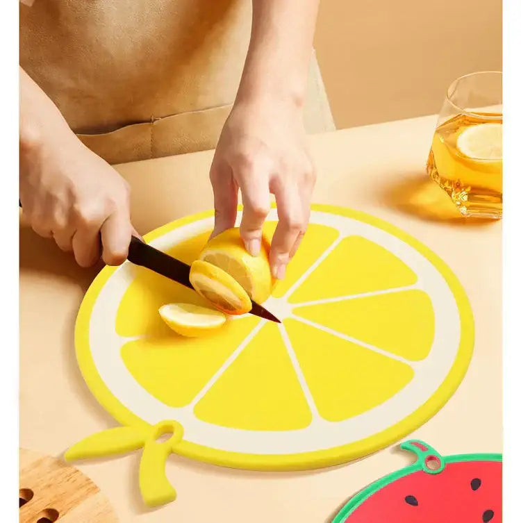 Yellow fruit shape silicone chopping board with white segmented design and green stem decorbites fruit shape kitchen decor