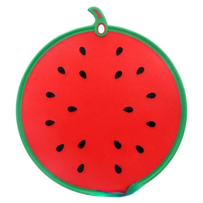 Red watermelon-shaped silicone pot holder with green rind and black seeds complements yellow fruit shape silicone chopping board decorbites fruit shape