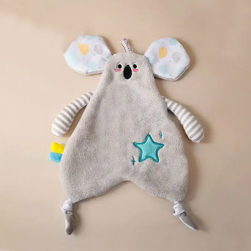 Soft gray koala-shaped baby comforter with striped arms and teal star detail alongside yellow giraffe decorbites cartoon animals hand towel