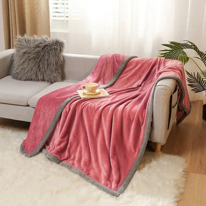 Pink plush throw blanket with gray textured border draped over sofa featuring decorbites cartoon flannel design