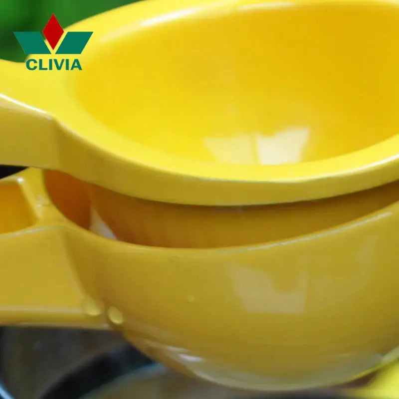 Bright yellow aluminum hand press citrus juicer with ergonomic handle and glossy finish for kitchen lemon squeezing