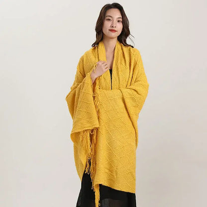 A vibrant yellow decorbites knitted diamond blanket with fringed edges ideal as a bedroom shawl wrap
