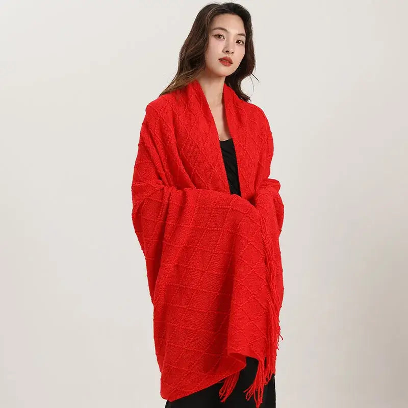 Vibrant red decorbites knitted diamond wrap with fringed edges featured as a knitted diamond blanket and shawl wrap