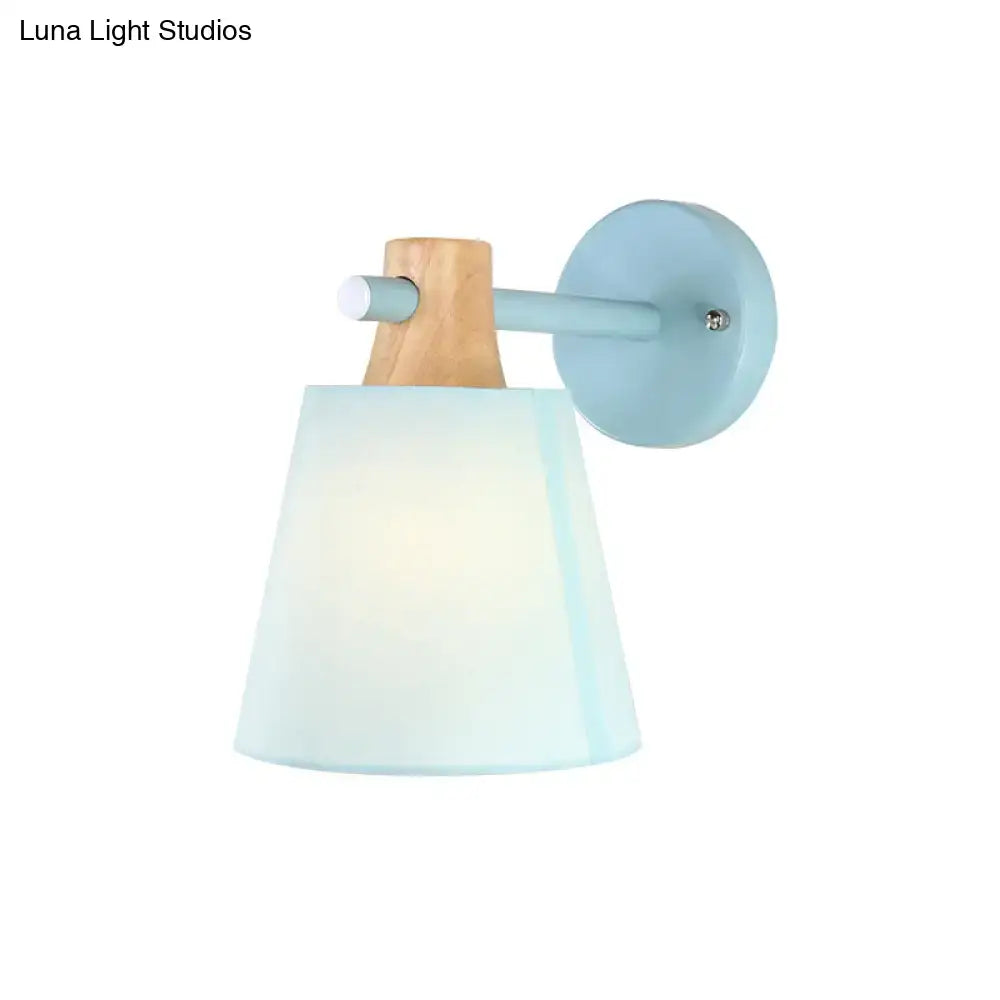 Pastel blue wall light with wooden accent and frosted glass shade featuring macaron fabric for bedroom use