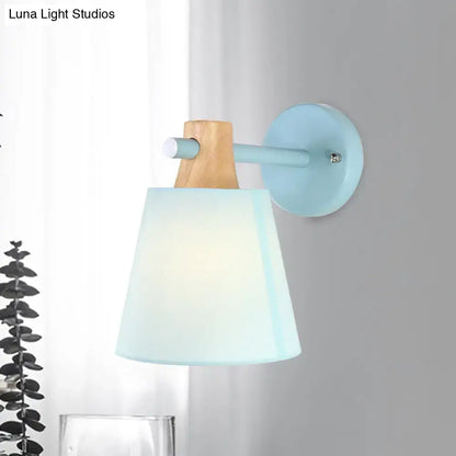 Yellow macaron fabric wall light with wood accent features a blue metal base and translucent macaron fabric shade for e26 e27 bulbs