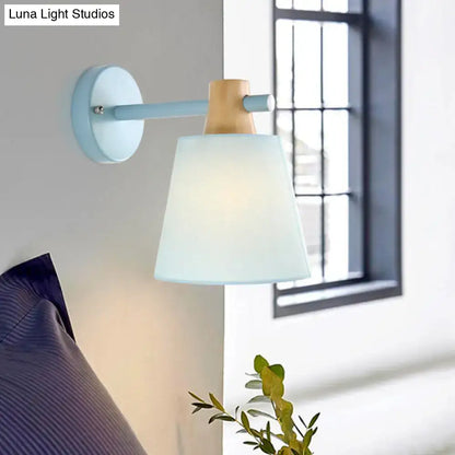 Light blue wall light with macaron fabric shade wooden accent and frosted glass designed as a bedroom sconce