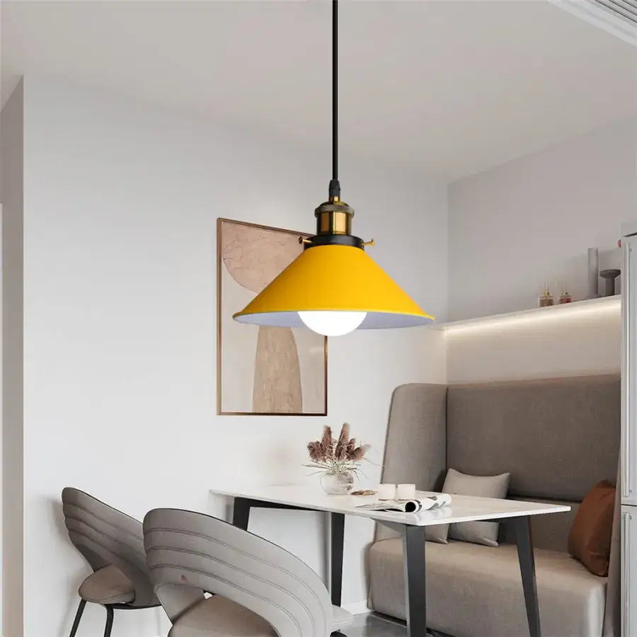 A vibrant yellow conical pendant light with brass accents and black cord for decorbites colorful nordic pendant decor