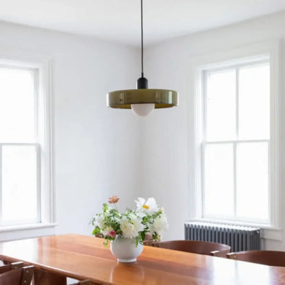 A nordic canteen chandelier kitchen pendant light with brass circular shade, frosted bulb, and black hanging cord
