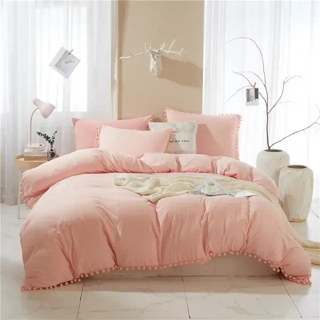 Pink quilted bedding set with pom-pom trim from decorbites furball tasseles bedding for bedroom decor