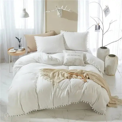 Cream-colored quilted comforter with soft pom-pom trim from decorbites furball tasseles bedding set for stylish decor