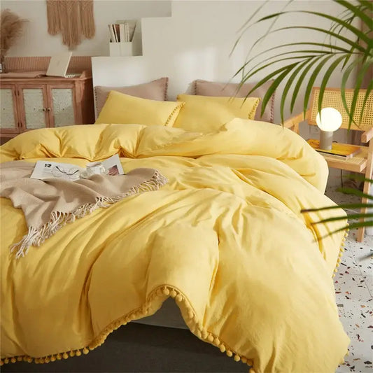 Bright yellow quilted bedding set with pom-pom trim from decorbites furball tasseles furball tasseles bedding