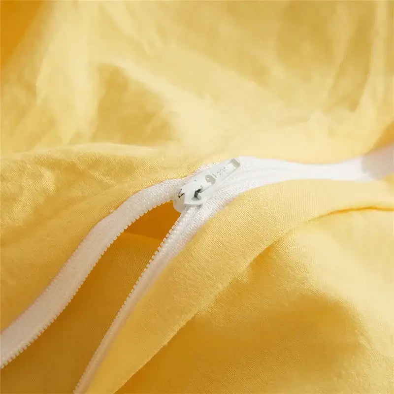 Yellow quilted furball tasseles bedding set with pale yellow fabric and white zipper closure by decorbites furball tasseles