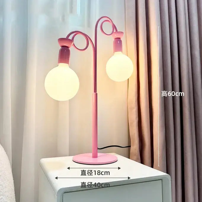 Pink metal floor lamp with two curved arms and spherical bulbs from decorbites colorful led floor bedroom art light collection