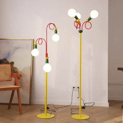 Vibrant yellow floor lamp with red and green curved arms and white globe bulbs by decorbites colorful led floor lamp