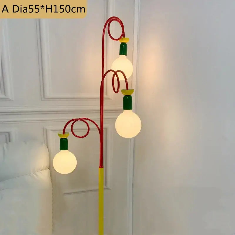 A vibrant yellow red and green colorful led floor lamp with three glowing spherical bulbs for bedroom decorbites