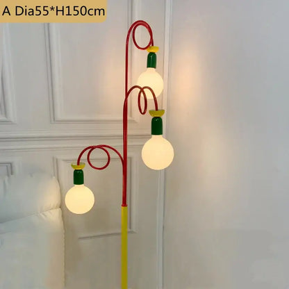 A vibrant yellow red and green colorful led floor lamp with three glowing spherical bulbs for bedroom decorbites