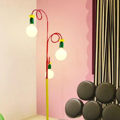 A vibrant red and yellow decorbites colorful led floor lamp with three glowing bulbs topped by green and yellow caps