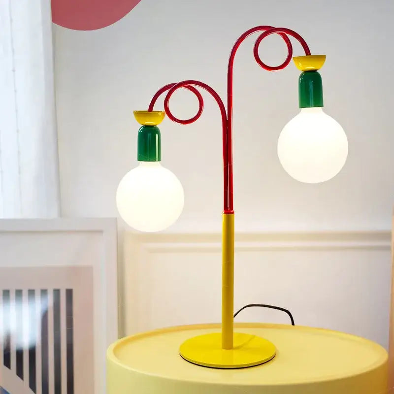 Vibrant red yellow and green colorful led floor lamp with two curved metal arms and bulb holders for decorbites colorful led