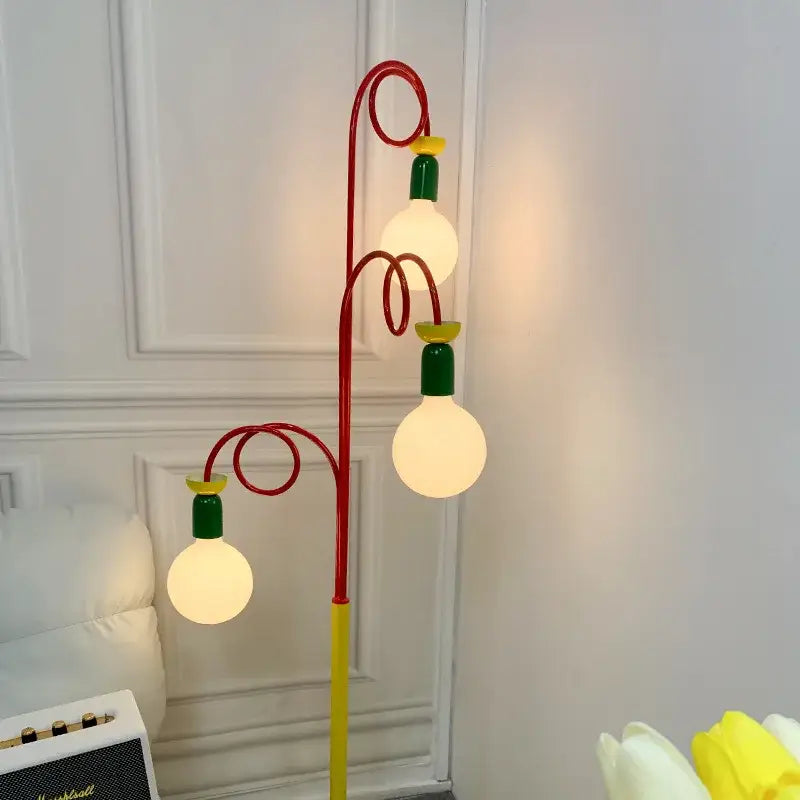 A whimsical yellow red and green colorful led floor lamp with three glowing globe bulbs for decorbites colorful led decor