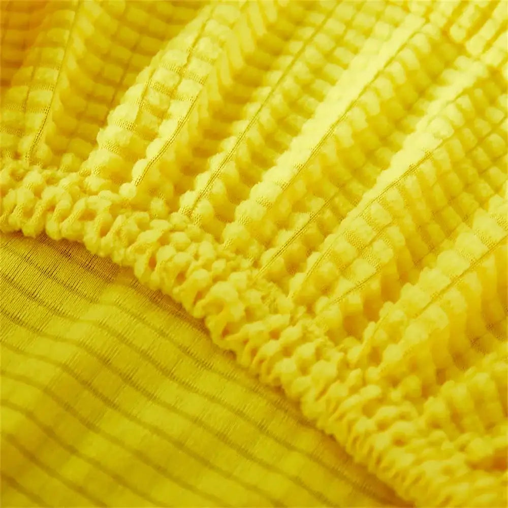 Yellow ribbed fleece chair cover made of textured stretchy knit fabric for dining room seat protection