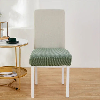 Green ribbed fleece chair cover snugly fits over white dining chair for seat protection and style with chair covers