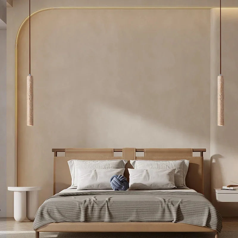 Modern beige leather bed with minimalist design and striped gray duvet under stone pendant light in bedroom