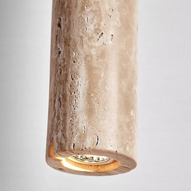 Yellow stone pendant light featuring a textured beige stone pendant light with integrated warm bulb for bedroom use