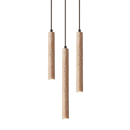 Three slender beige stone pendant lights with textured concrete surface hang from black cords for bedroom use
