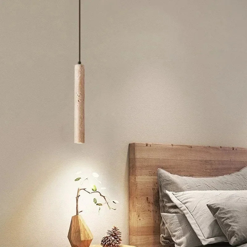 Yellow stone pendant light featuring a minimalist cylindrical stone pendant with natural textured finish for bedroom use