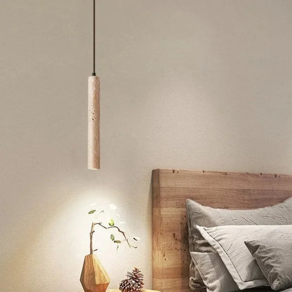 Yellow stone pendant light featuring a minimalist cylindrical stone pendant with natural textured finish for bedroom use