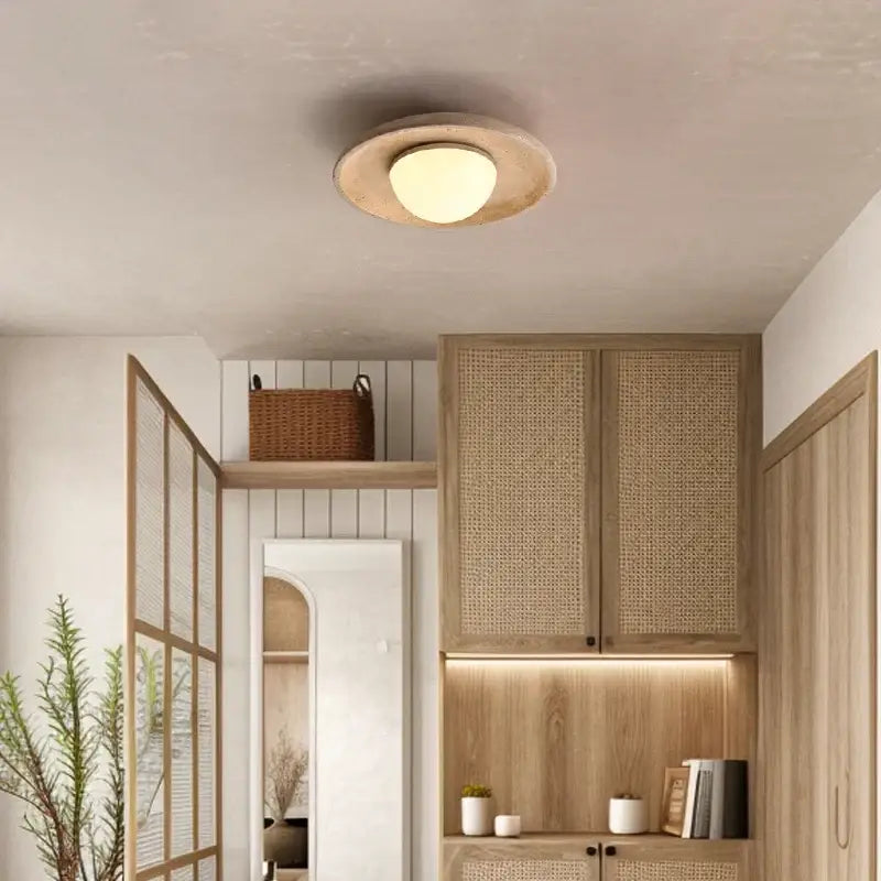 Warm yellow travertine led ceiling lamp with textured beige finish and soft glowing center for living room lighting