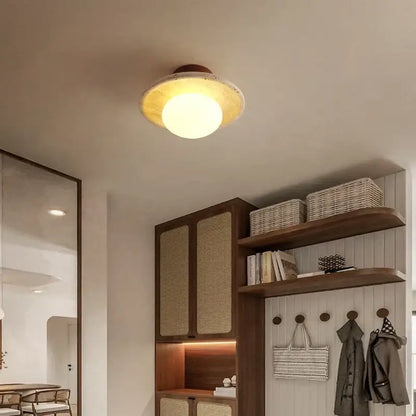 Warm-toned led ceiling lamp with yellow travertine rustic wooden base and circular frosted glass shade for living room