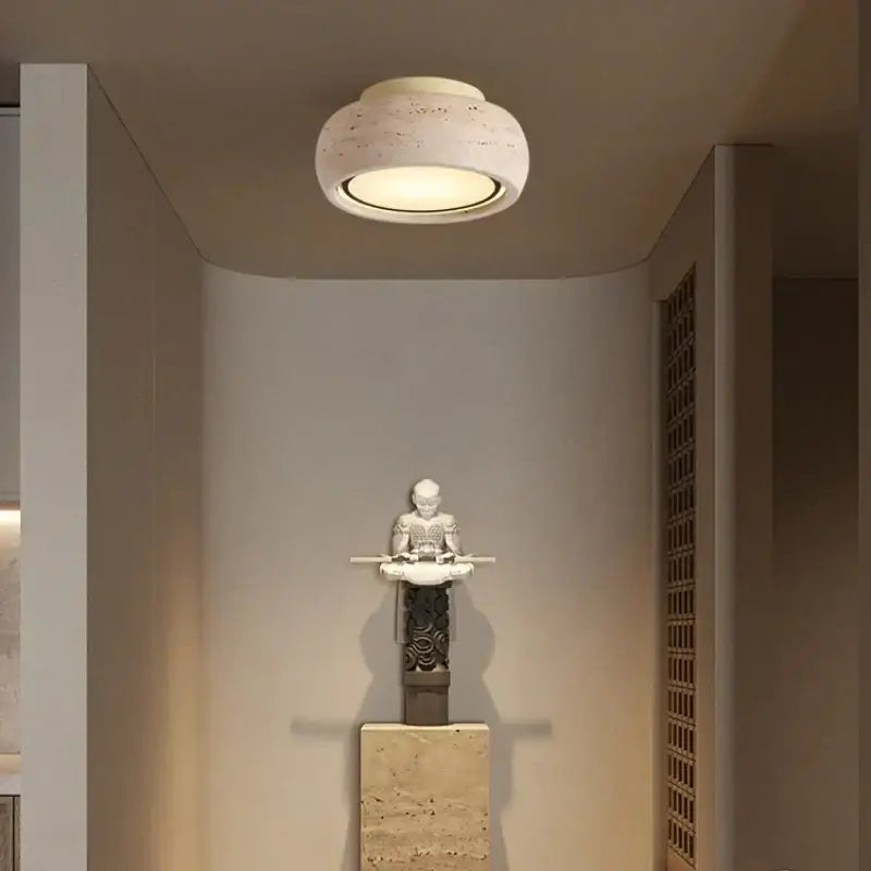 A modern ceiling light with a textured yellow travertine finish and warm glow decorbites led yellow for bedroom use