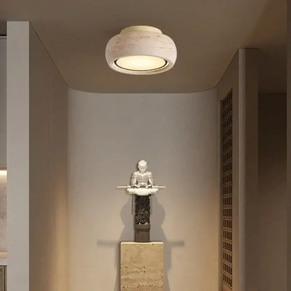 A modern ceiling light with a textured yellow travertine finish and warm glow decorbites led yellow for bedroom use