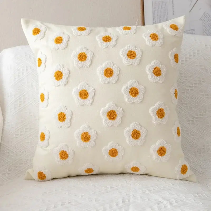 Cream-colored pillow cover with raised white and mustard-yellow embroidered flora cotton daisies for bedroom decor