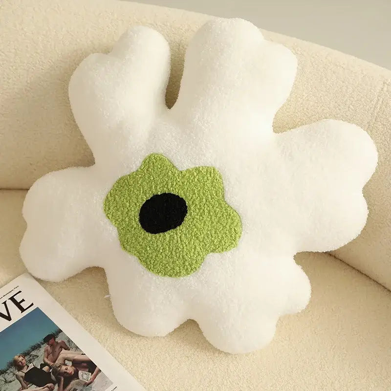 A plush white and yellow flower shaped decorative throw pillow with a green center and soft textured fabric by decorbites 3d flower