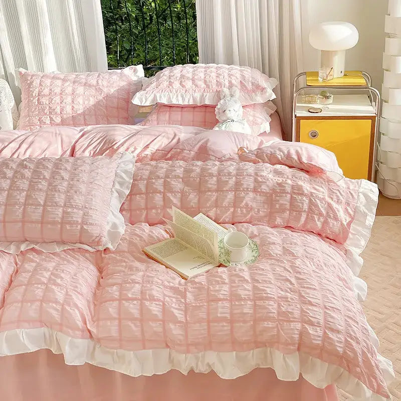 Pink quilted duvet cover set with white ruffled edges made of soft textured fabric for bedroom bedding use