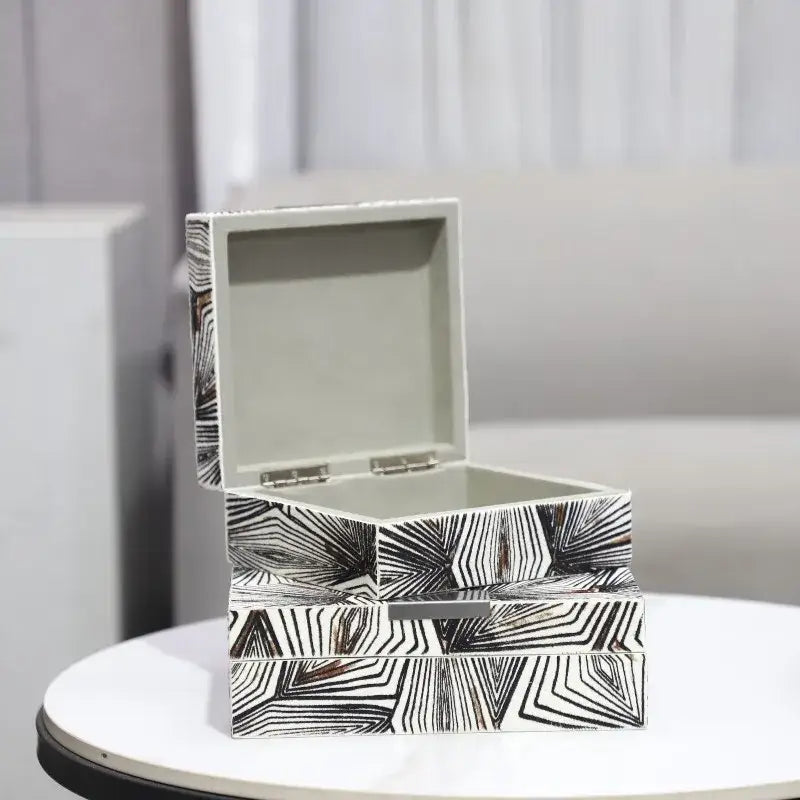 Zebra black and white jewelry storage box with modern geometric pattern metallic hinges and silver interior linings for desktop organization