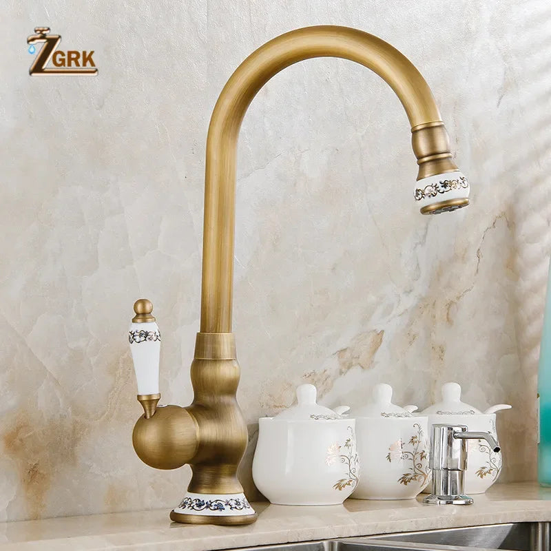 Antique brass single hole kitchen faucet with ornate white ceramic handles and decorative floral mixer tap housing material